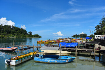 Fototapeta na wymiar Colorful fishing boats parked at the river mouth. Punts parked at the riverside.