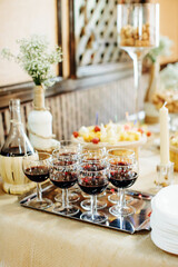 Wine Glasses with red wine, close-up. Details of festive buffet table. Selective focus.