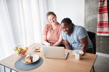 Couple having call with relatives after eating cake and drinking juice