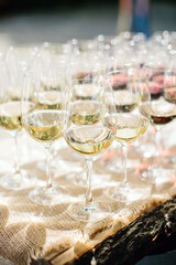 
Glasses with white wine, close-up. Details of the festive buffet table. Selective focus.