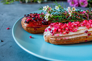 Fruity eclairs with flowers on a plate 