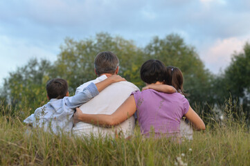 Fototapeta premium happy parents and children at summer field