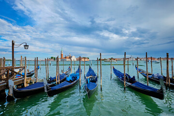 Fototapeta premium Gondolas and in lagoon of Venice by San Marco square. Venice, Italy