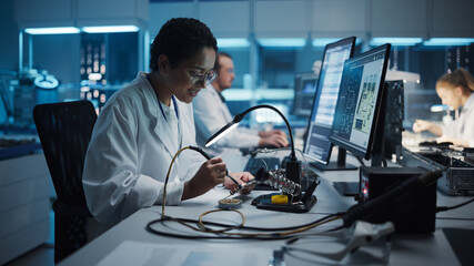 Modern Electronics Research, Development Facility: Black Female Engineer Does Computer Motherboard Soldering. Scientists Design Industrial PCB, Silicon Microchips, Semiconductors.