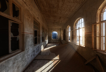 Fototapeta premium Abandoned building being taken over by encroaching sand, Kolmanskop ghost town, Namib Desert
