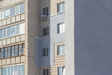 Multi-storey house with a gray wall insulated with foam to protect against frost in winter. Copy...