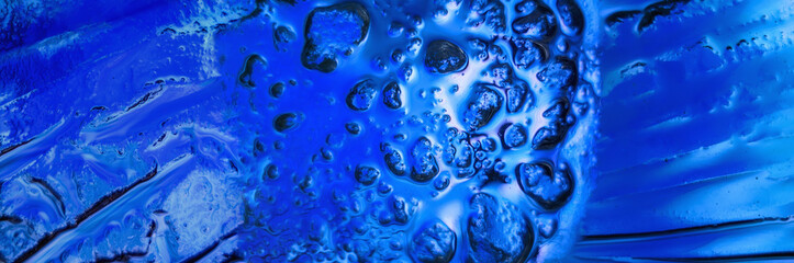 Rough surface of blue glass close up 