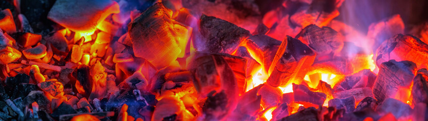 Hot coal pieces with orange yellow flame