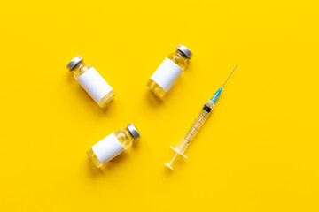 Covid vaccine in bottles with syringe. Top view