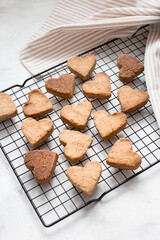 homemade heart-shaped cookies cool on the grill, valentine's day gift with love, gluten-free buckwheat flour pastries.