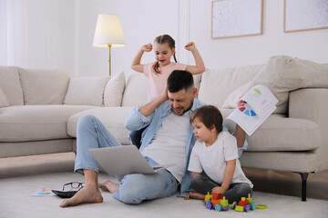 Overwhelmed man combining parenting and work at home