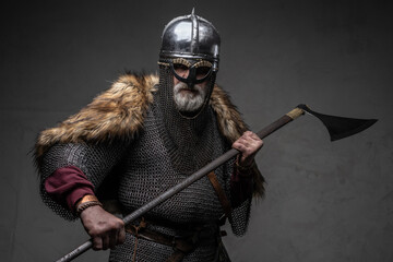 Violent viking fighter dressed in authentic armored clothing