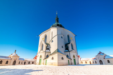 Fototapeta premium The Pilgrim Church of St. John of Nepomuk on Zelena Hora - Green Mountain, Zdar nad Sazavou, Czech Republic, UNESCO heritage. Winter weather with snow. Sunny frozen day.