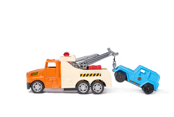 An orange tow truck is towing a blue car. Toy cars on white background