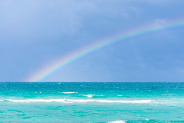 Rainbow on a cloudy day at the beach