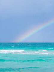 Rainbow on a cloudy day at the beach