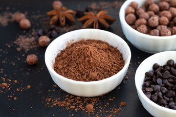 Dessert cooking ingredients background chocolate morsels and cocoa powder