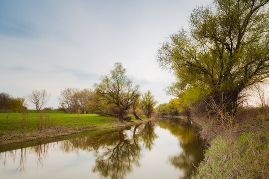 Long exposure photo of calm river in spring on a rainy day