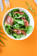 green salad jamon meat jerky dry-cured pork leg mix leaves vegetables on the table healthy food meal snack copy space food background rustic. top view