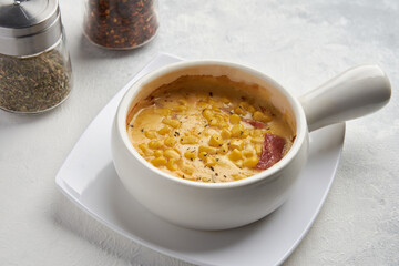 delicious plate of corn with cheese melt with bacon