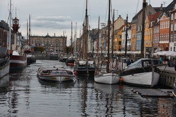 Copenhagen, Denmark - Juli 1, 2020 Street view of the colorful building in Nyhavn in Cophenhagen with people walking the street in front. High quality photo
