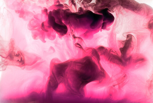 Abstract pink purple cloud of smoke, paint in water background. Fluid art wallpaper, liquid vibrant bright colors. Concept aphrodisiac perfume