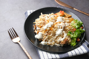 indian plane rice with slice of chicken meat and lettuces on plate 