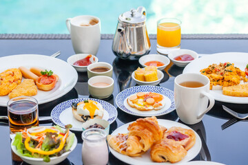 American Breakfast Set with Teapot on Table Next to Poolside in Resort. English Morning Food Near Swimming Pool in Luxury Hotel. Summer Holidays in Tropical Country, Thailand. Travel and Relax