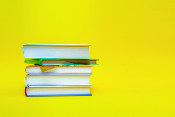 Stack of books on yellow background for business and education, back to school, learning and education concept. space for banner for text
