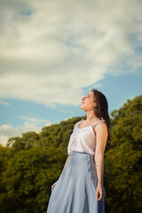 Young woman under the sun and big sky.