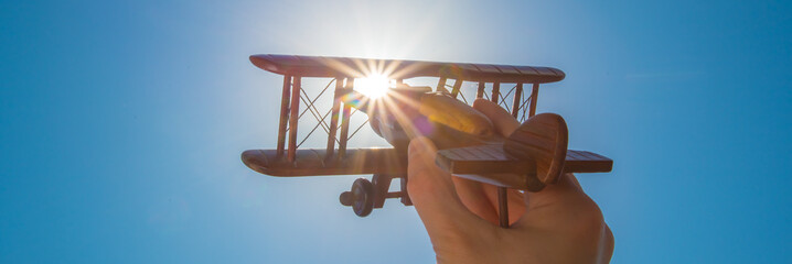 Toy plane by sun background