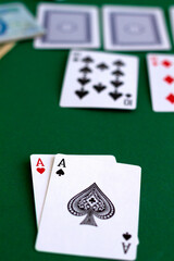 poker cards and chips.card red and black aces in casino. playing cards with blue deck on the green table. combination of cards on a green casino desk background.copy space. vertical