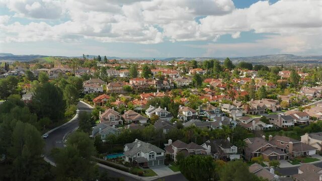 Rising aerial drone footage over hill top housing, in the Canyon Crest neighborhood, Mission Viejo, California.