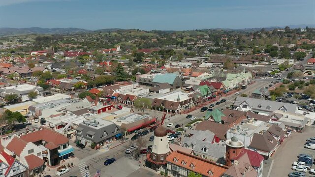 Aerial sliding drone footage of the windmill in the town of Solvang, California.