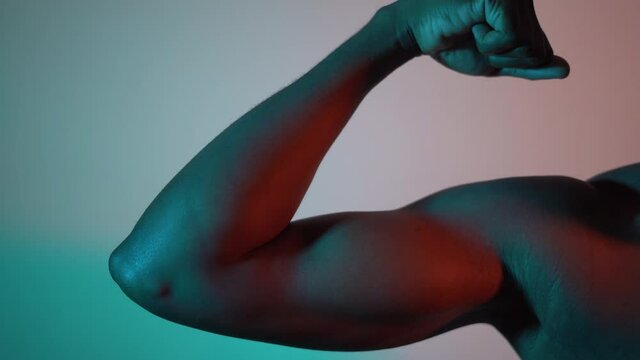 Muscular black male flexing his bicep muscle. Strong black male showing his bicep muscle. 