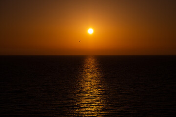 Amazing sunset on the sea horizon with clear sky without clouds