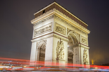 Fototapeta na wymiar Paris, France - February 3, 2017: Paris Arc de Triomphe long exposure with traffic lights. Majestic Structure