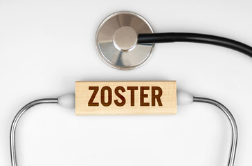 On the table is a stethoscope and a wooden plate with the inscription - ZOSTER