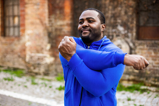 Sporty man enjoys  exercising outdoor.