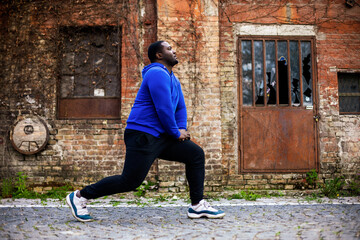 Sporty man enjoys  exercising outdoor.