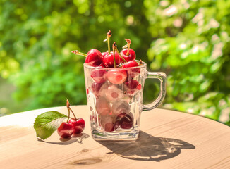 Fresh cherries in glass containers on a summer day