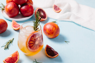 Delicious Blood Orange Gin Cocktail on light blue background. Summer cocktails, refreshing drinks,...