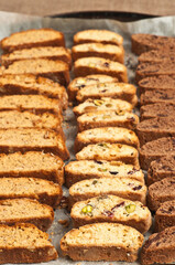 top view, medium distance of rows of a veriaty of freshly baked biscotti's, on a baking sheet