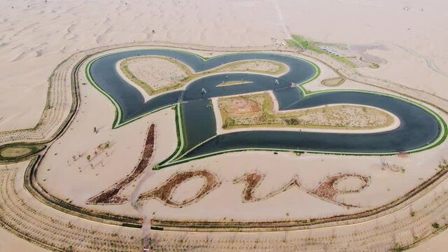 Heart shape Love lake in Dubai desert in Al Qudra area aerial view