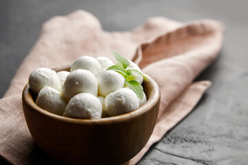 Bowl with italian mini mozzarella cheese balls on linen napkin background