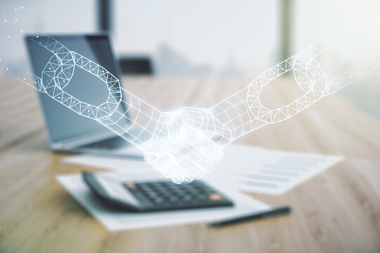 Abstract virtual blockchain technology hologram with handshake on calculator and laptop background. Digital money transfers and decentralization concept. Multiexposure
