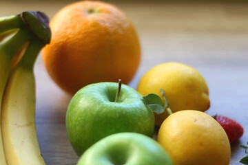 Various colorful fruit on wooden background. Selective focus.