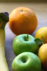 Various colorful fruit on wooden background. Selective focus.