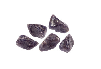 Purple color tumbled Iolite or Cordierite gemstones, isolated on white background, lot of copy space. Studio shot. Also called 