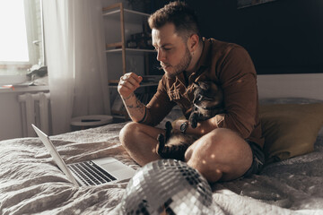 Man smoking cannabis and spending time with his cat